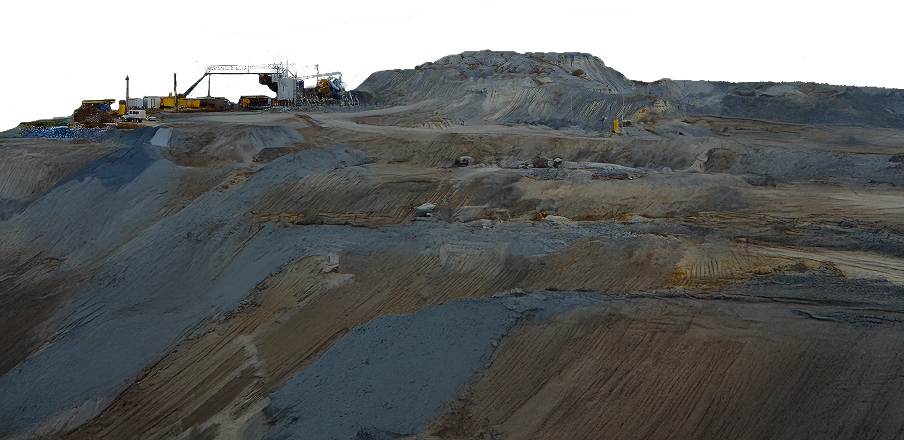 A large mound with industrial equipment