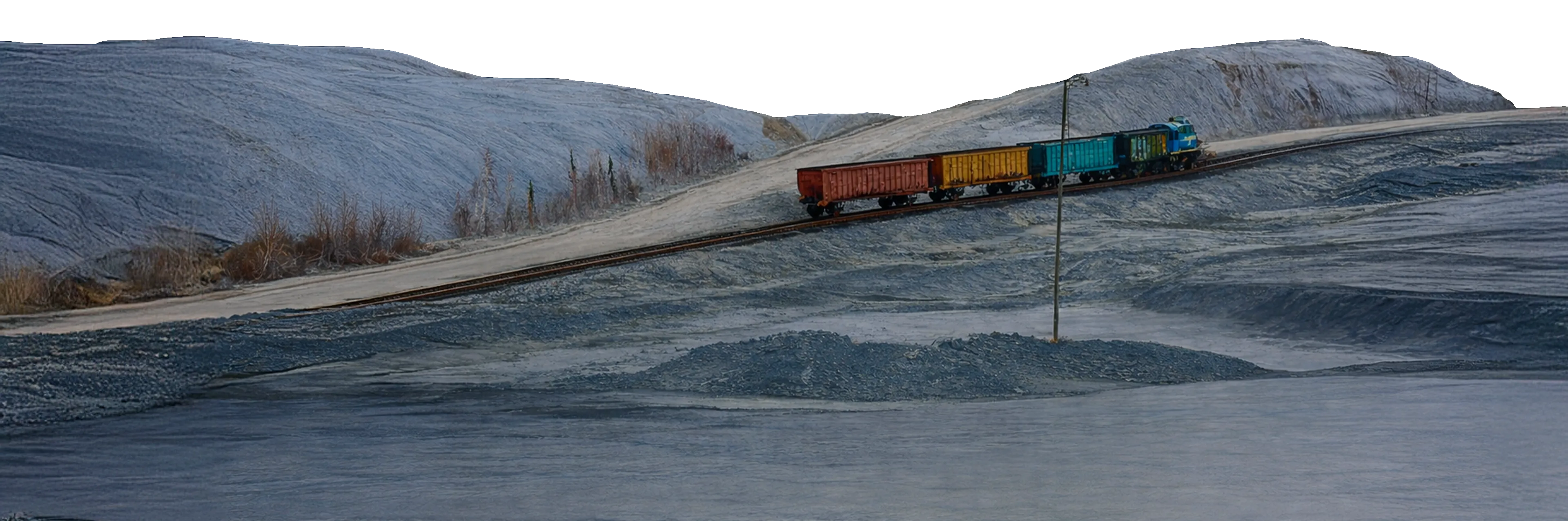 Mounds with an industrial train passing in the foreground